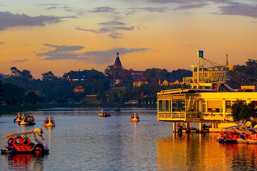 Unwind in peaceful serenity by Xuan Huong Lake, where pine-lined paths, calm waters, and cool mountain air offer the perfect escape in the heart of Da Lat 